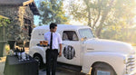 Black tie outdoor wedding event with white classic truck and draft beer.